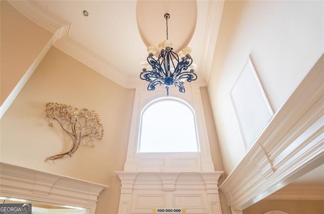 interior details with a chandelier and ornamental molding