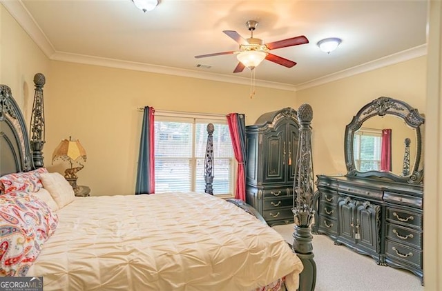 carpeted bedroom with ceiling fan and crown molding