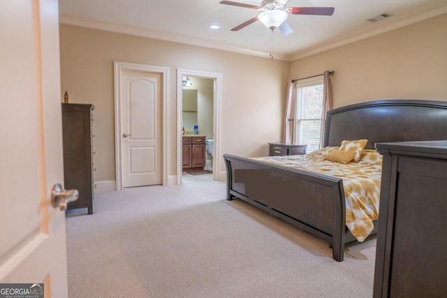 carpeted bedroom featuring ceiling fan, ensuite bathroom, and ornamental molding