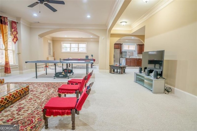 playroom featuring light carpet, crown molding, and ceiling fan