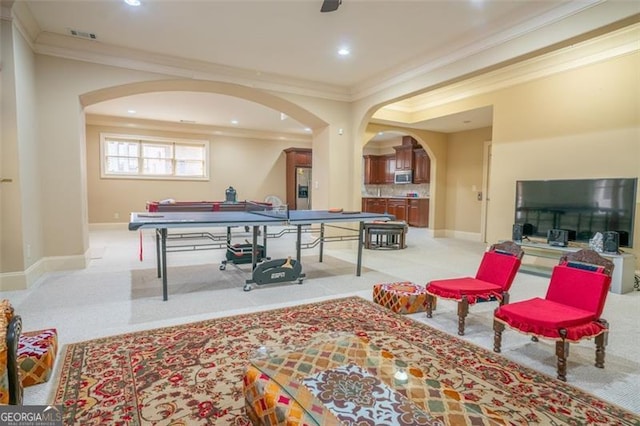 recreation room featuring crown molding