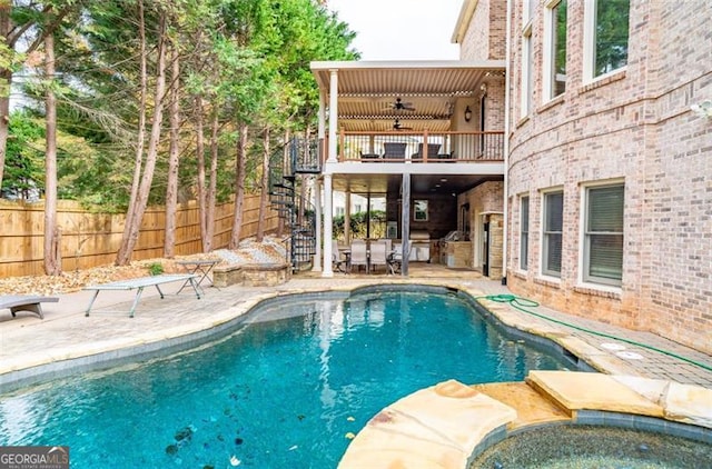 view of pool featuring a patio area, ceiling fan, and an in ground hot tub