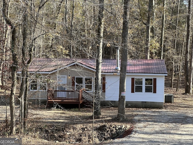 view of front of property featuring a deck and cooling unit