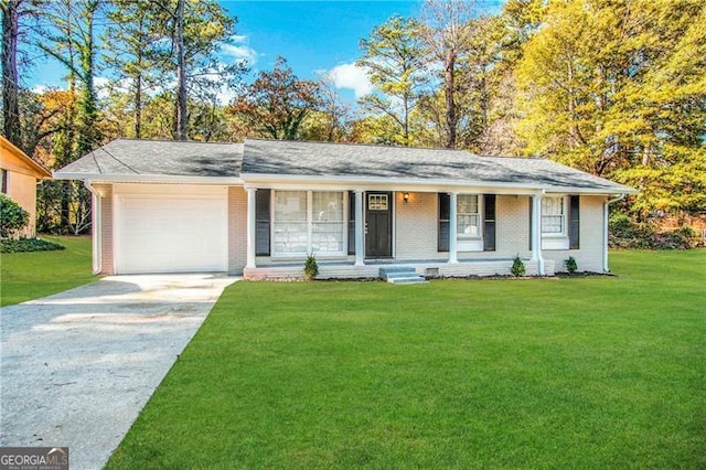 ranch-style house featuring covered porch, a garage, and a front yard