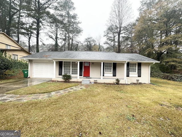 ranch-style home with a porch, a front yard, and a garage