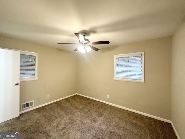 spare room with ceiling fan and carpet floors