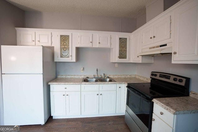 kitchen with stainless steel electric range, white cabinets, sink, white fridge, and extractor fan