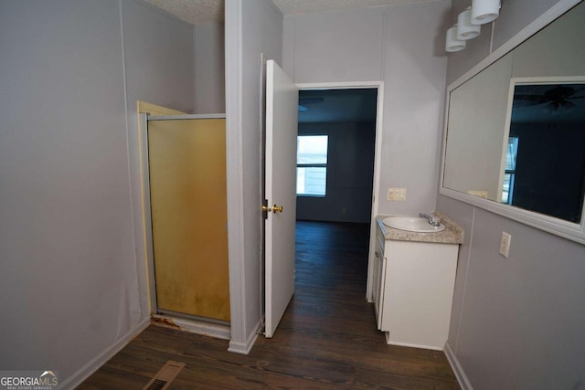 hall with a textured ceiling, sink, and dark hardwood / wood-style floors