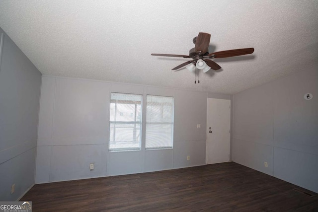 unfurnished room featuring ceiling fan, dark wood-type flooring, and a textured ceiling