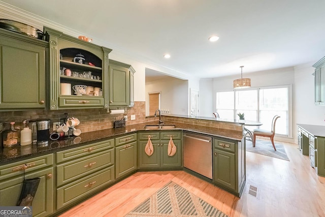 kitchen with dishwasher, green cabinets, sink, decorative light fixtures, and kitchen peninsula