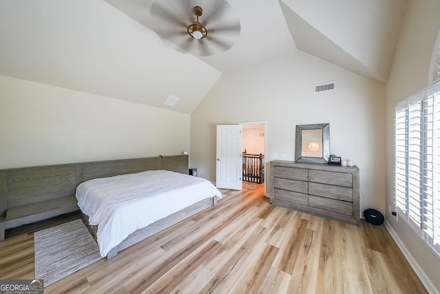 bedroom with ceiling fan, light hardwood / wood-style flooring, and vaulted ceiling