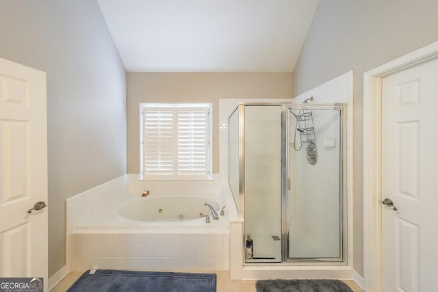 bathroom featuring separate shower and tub and vaulted ceiling