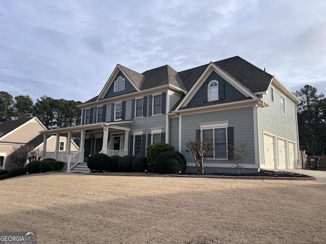 view of front of house featuring a porch and a garage