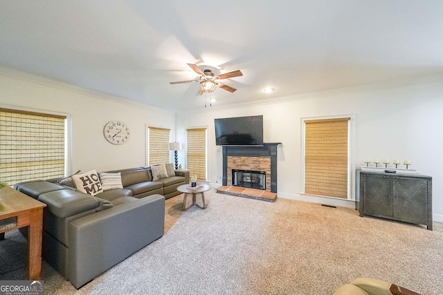 living room with a fireplace, carpet, and crown molding