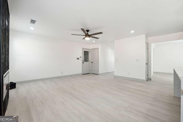 empty room featuring ceiling fan and light hardwood / wood-style floors