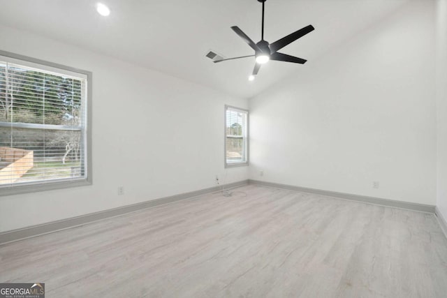 unfurnished room featuring light hardwood / wood-style flooring, ceiling fan, and lofted ceiling