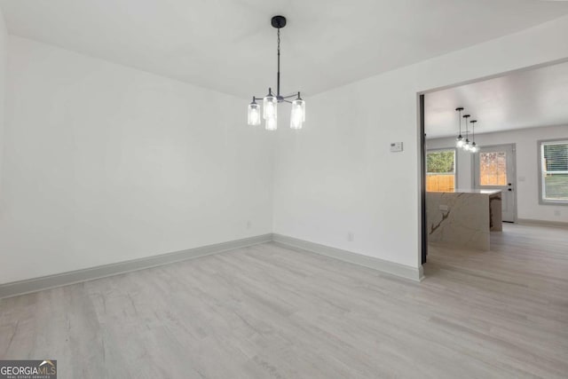 spare room featuring light wood-type flooring