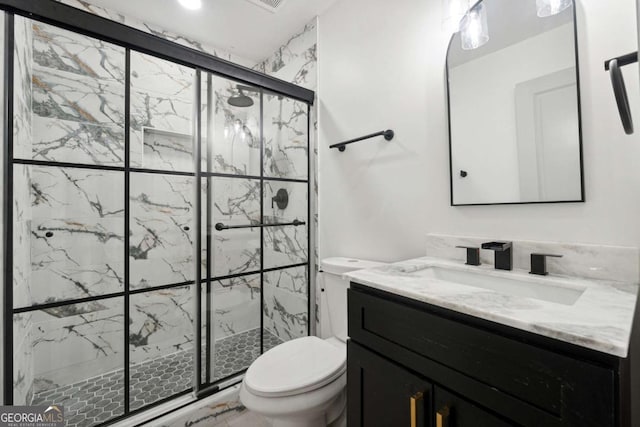 bathroom with vanity, toilet, and a shower with door