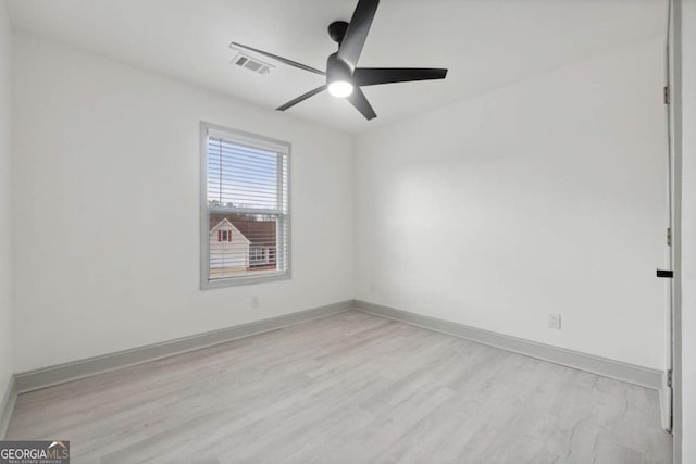 empty room featuring ceiling fan and light hardwood / wood-style flooring