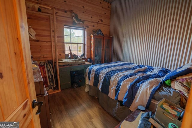 bedroom featuring wood walls and wood-type flooring