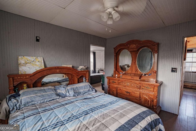 bedroom with radiator, ceiling fan, and dark hardwood / wood-style floors