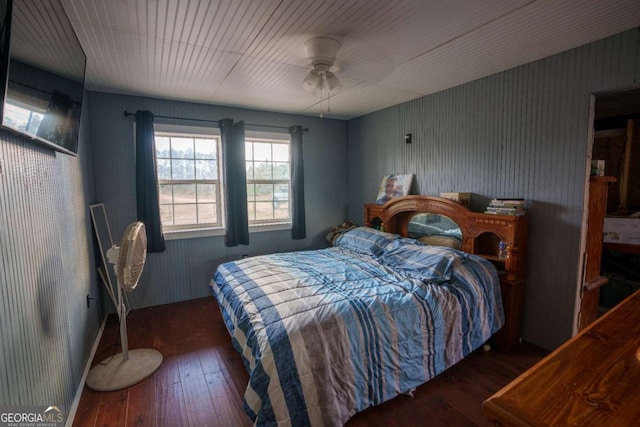 bedroom with ceiling fan and dark wood-type flooring