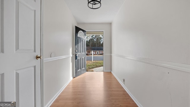 hallway featuring a textured ceiling and light hardwood / wood-style flooring