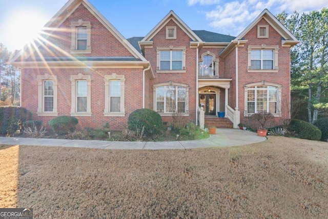 view of front of home featuring french doors and a balcony