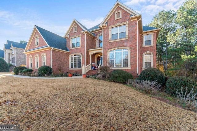 view of front of house with covered porch and a front yard