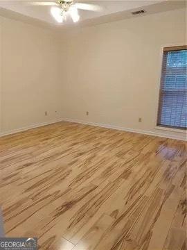 unfurnished room with ceiling fan and light hardwood / wood-style floors