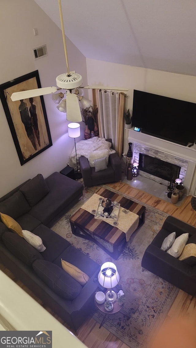 living room featuring wood-type flooring and lofted ceiling