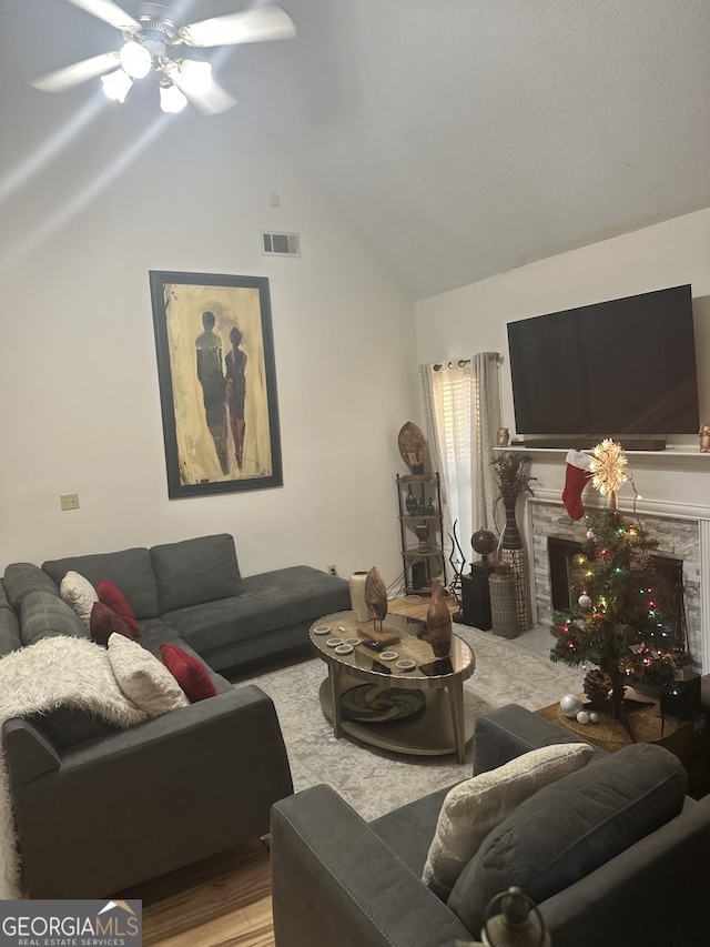 living room with hardwood / wood-style flooring, high vaulted ceiling, and ceiling fan