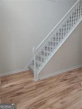 stairs with wood-type flooring