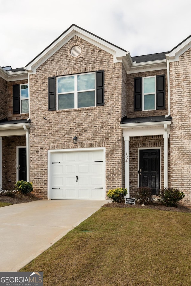 view of front of house with a garage and a front yard