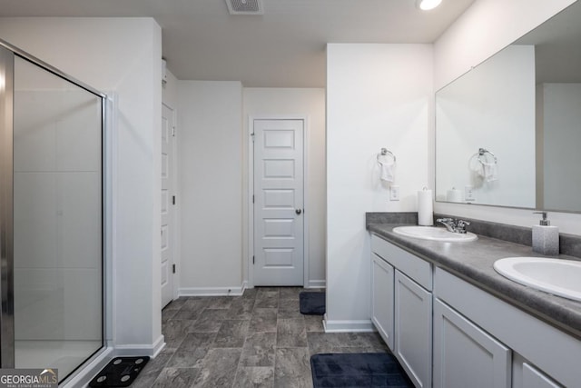 bathroom featuring vanity and a shower with shower door