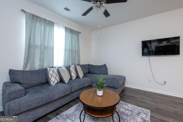 living room with ceiling fan and dark hardwood / wood-style flooring