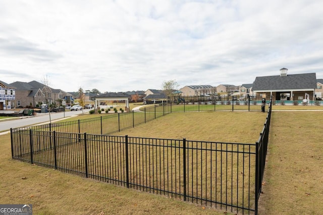 view of property's community featuring a yard