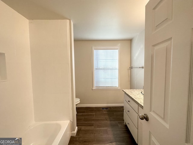 bathroom with hardwood / wood-style flooring, vanity, and toilet