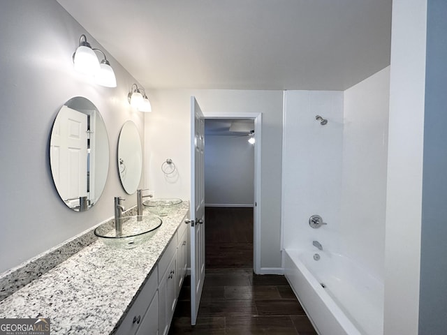 bathroom featuring vanity, hardwood / wood-style flooring, ceiling fan, and tub / shower combination