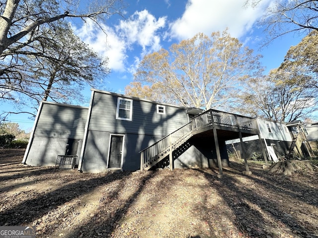 back of house featuring a wooden deck