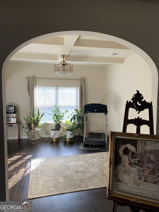 interior space featuring dark wood-type flooring and coffered ceiling