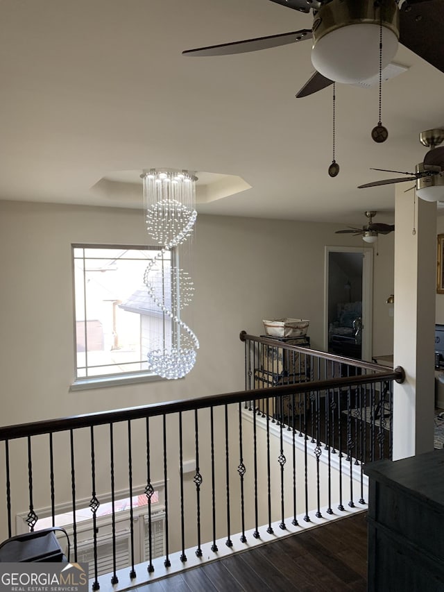 stairway featuring wood-type flooring and a chandelier