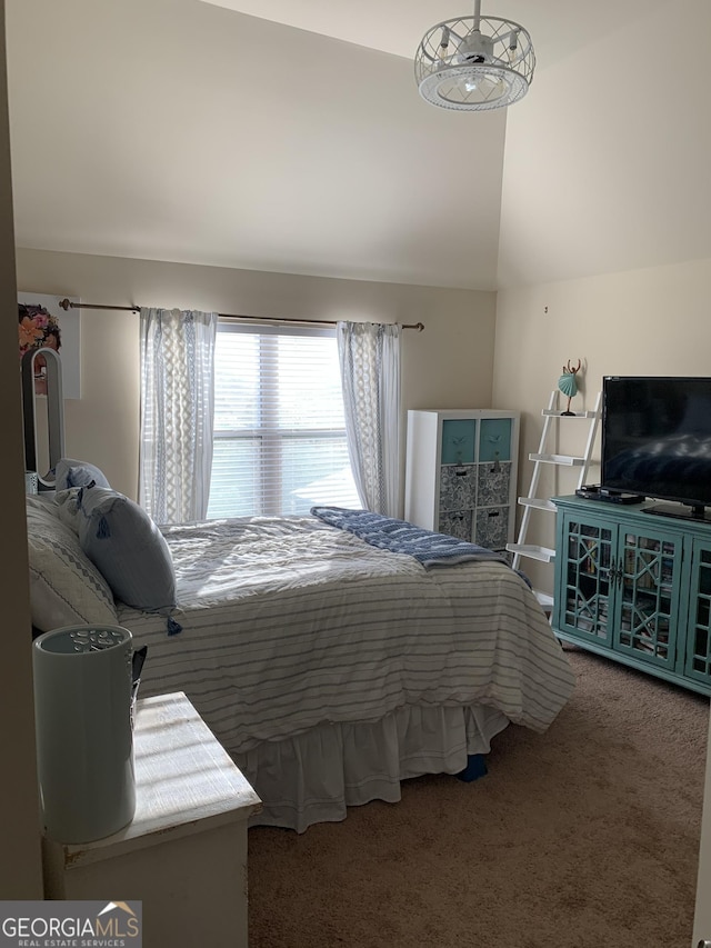 bedroom featuring lofted ceiling and carpet floors