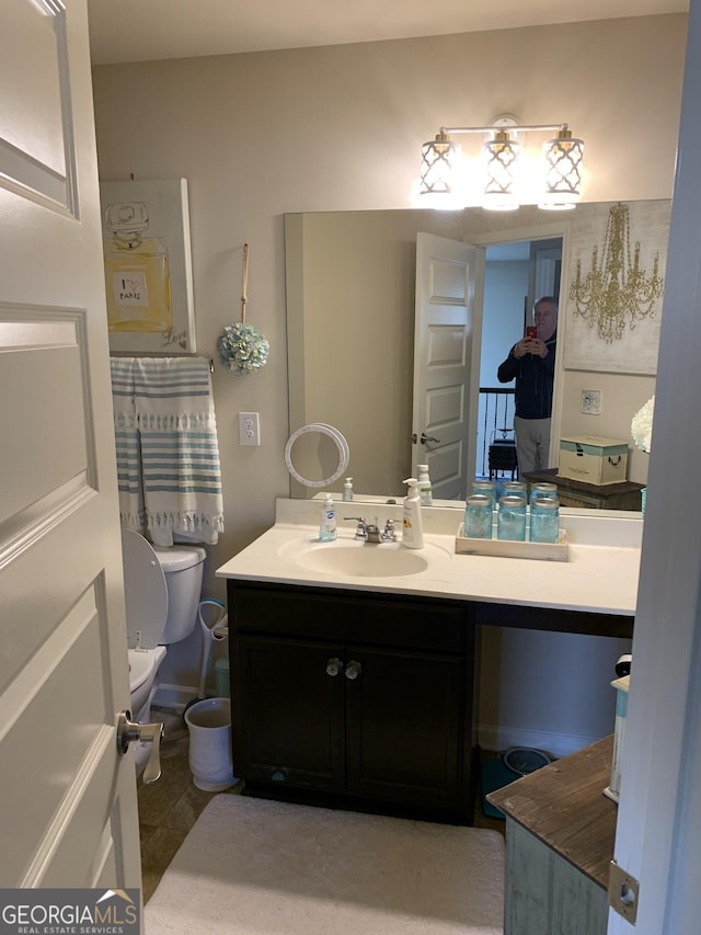 bathroom with tile patterned floors, vanity, and toilet