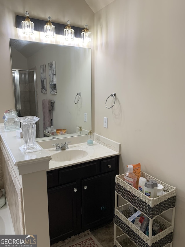 bathroom featuring vanity, vaulted ceiling, and an enclosed shower