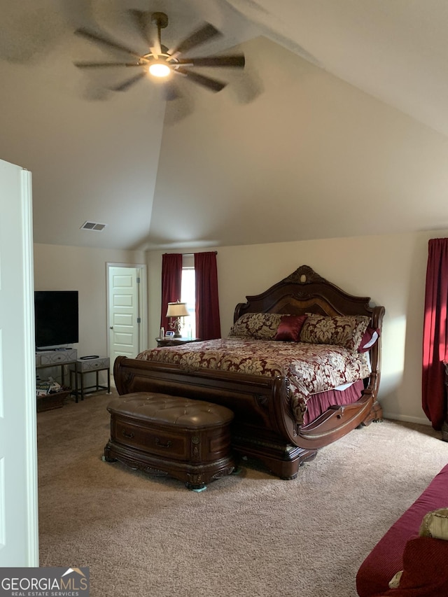 bedroom with ceiling fan, carpet floors, and vaulted ceiling