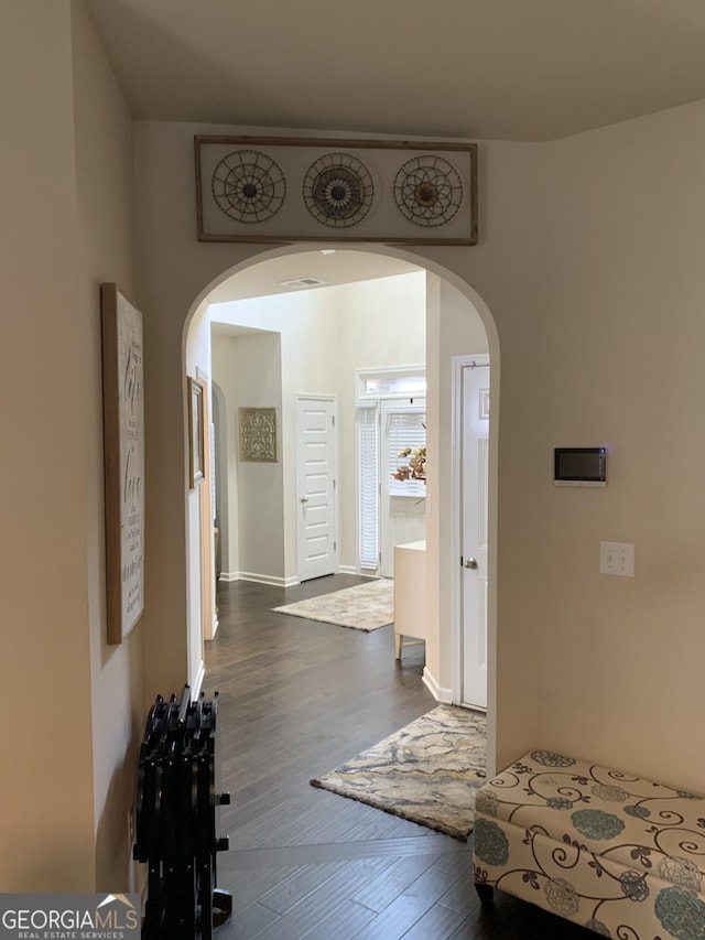 corridor with dark hardwood / wood-style flooring