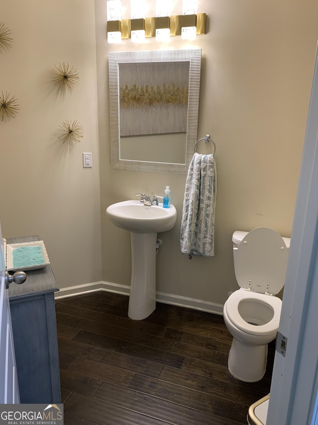 bathroom featuring hardwood / wood-style floors and toilet