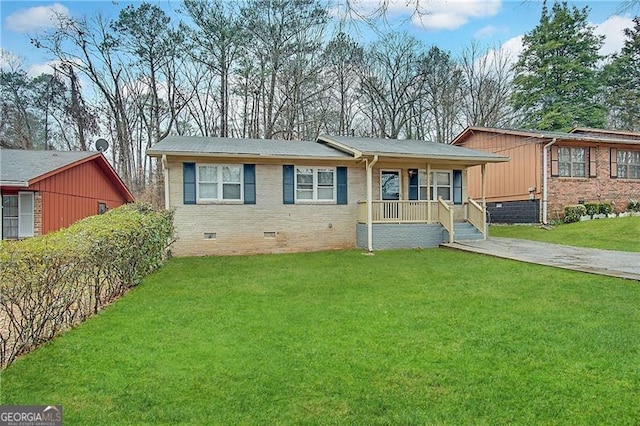 ranch-style home with covered porch and a front yard