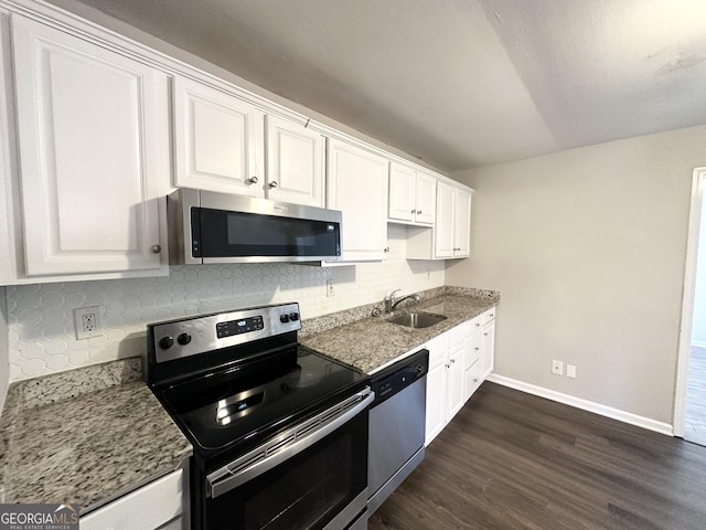 kitchen with sink, stainless steel appliances, tasteful backsplash, dark hardwood / wood-style flooring, and white cabinets